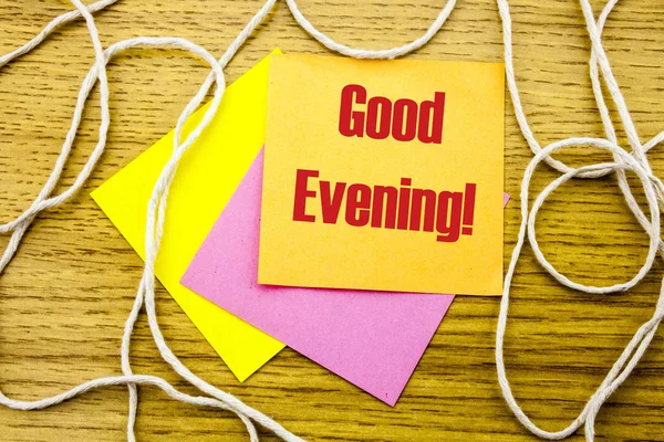 Good Evening word on yellow sticky note in wooden background. Bussines concept.