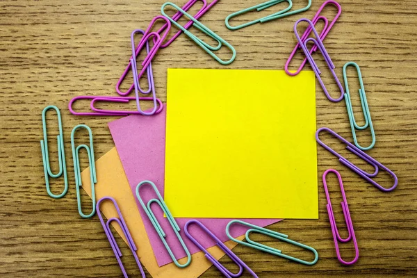 Paper sticker note on wooden background. Blank forms for workers notes.