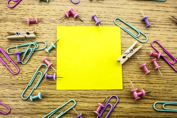 Paper sticker note on wooden background. Blank forms for workers notes.