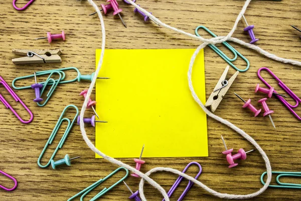 Paper sticker note on wooden background. Blank forms for workers notes.