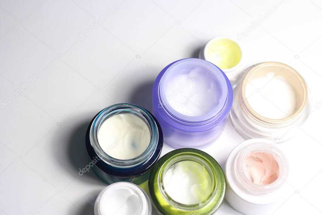 Mix of face creams for beautiful skin in the vivid colorful jars