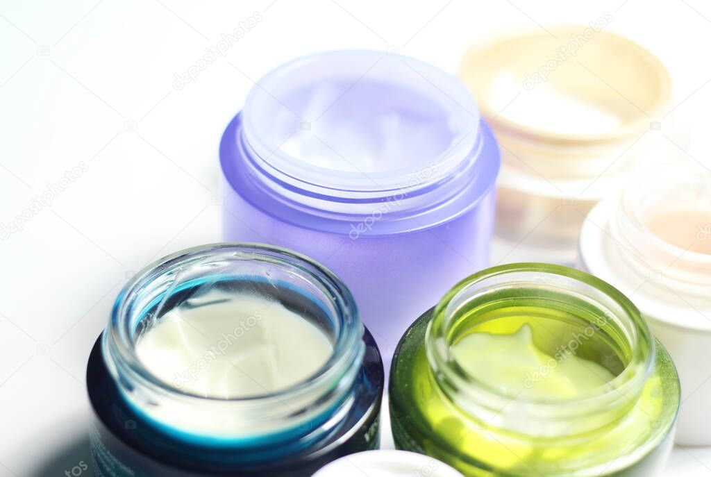 Mix of face creams for beautiful skin in the vivid colorful jars