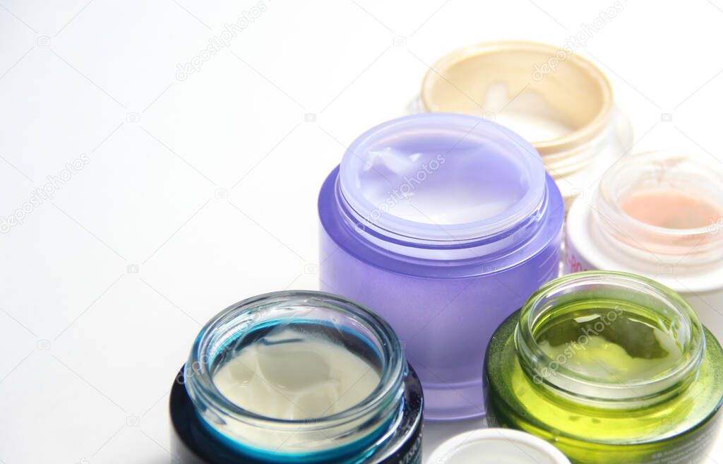 Mix of face creams for beautiful skin in the vivid colorful jar