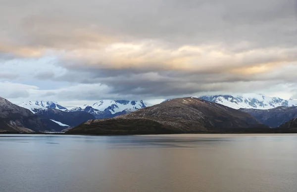 Of The Beagle Channel. Andes. Like the Strait of Magellan, the Beagle Strait is located between Tierra del Fuego and Antarctica. The Strait is bordered to the Northwest by the Cordillera - Darwin mountain system.