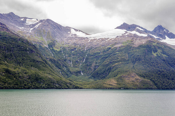 Of The Beagle Channel. Andes. Like the Strait of Magellan, the Beagle Strait is located between Tierra del Fuego and Antarctica. The Strait is bordered to the Northwest by the Cordillera - Darwin mountain system.