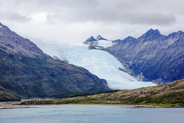 Of The Beagle Channel. Andes. Like the Strait of Magellan, the Beagle Strait is located between Tierra del Fuego and Antarctica. The Strait is bordered to the Northwest by the Cordillera - Darwin mountain system.