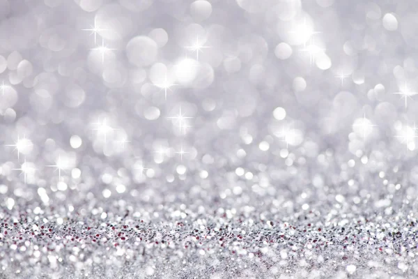 Silberglitzernde Weihnachtsbeleuchtung. verschwommener abstrakter Hintergrund — Stockfoto