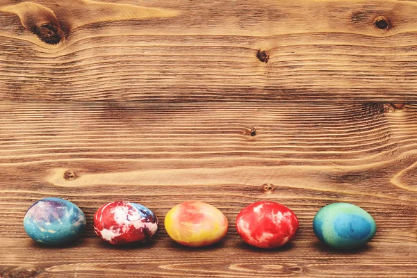 Colorful Easter eggs on wooden background. — Stock Photo, Image