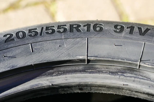 Side view of new tire with tire width, height and wheel diameter designation