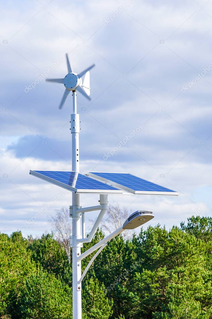 Street light with solar and wind power plant under clear sky