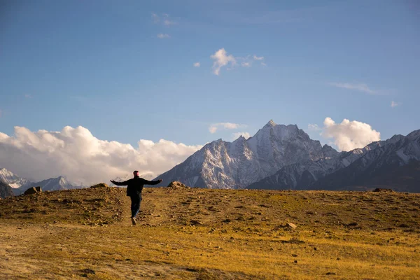 Man walking happily through mountain path Royalty Free Stock Images