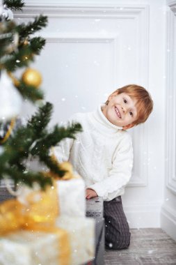 Beyaz kazaklı komik küçük çocuk.