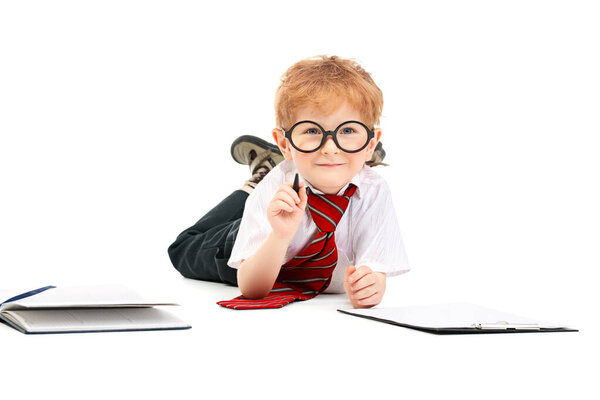 Портрет улыбающегося школьника, пишущего в блокноте. Детская мода для школы, канцелярские принадлежности, образование
.