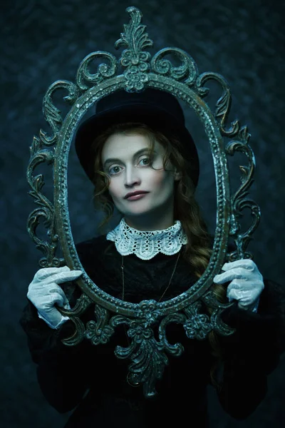 Portrait of a beautiful Victorian woman in an old vintage frame. Steampunk.