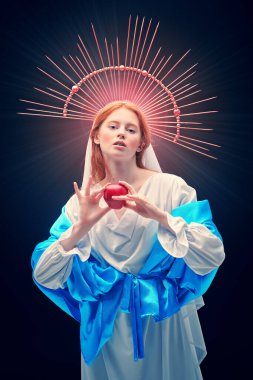 Modern din sanatı. Meryem Ana bir elmayı karanlık bir arka planda tutuyor ışık ışınlarıyla. 