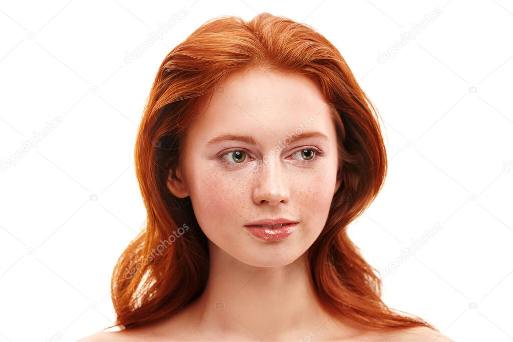 Portrait of a beautiful smiling young woman with magnificent red hair with freckles on her face. Beauty, hair and skin care. Hair coloring. White background with copy space.
