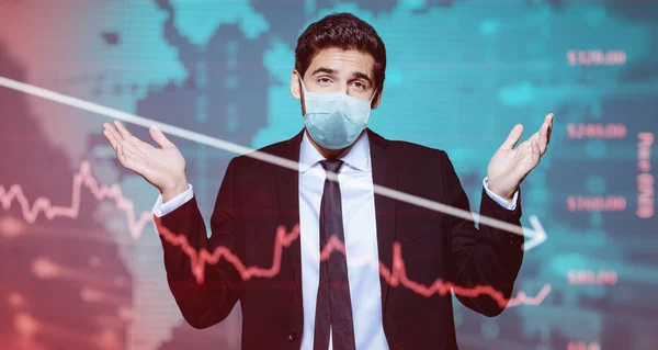Coronavirus and business. A businessman in a medical mask makes a helpless gesture against the background of a coronavirus and stock charts.