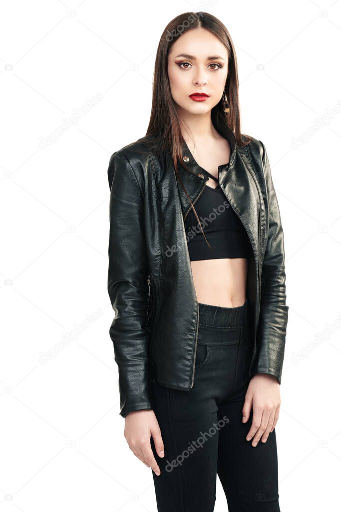 Fashion shot. Portrait of a beautiful brunette girl posing in black clothes on a white background. Studio shot.