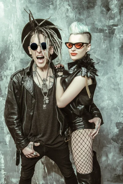 A portrait of two stylish punk people. Modern men fashion, rock musicians.