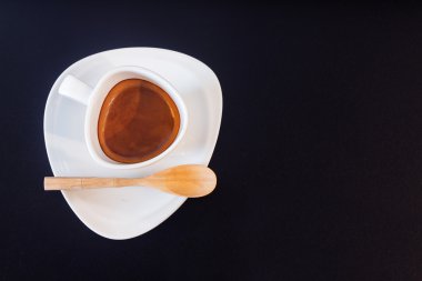 Siyah cam masa üzerinde beyaz kahve fincanı