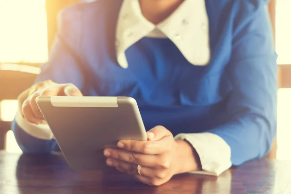 woman using tablet computer in cafe. Focus on tablet.