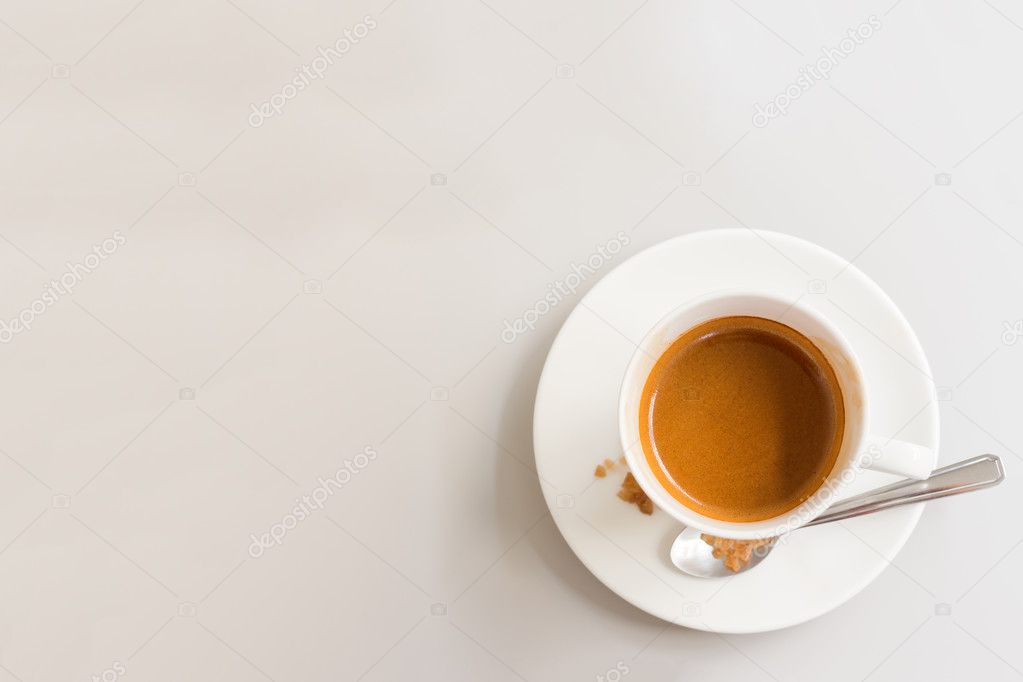 White cup of coffee on white wood table