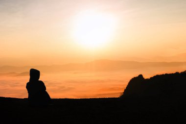 silhouette young woman watching sunset clipart