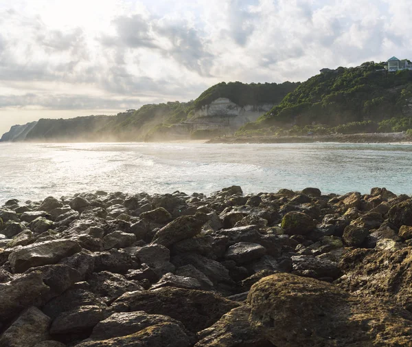 Rocky ocean coast on sunset in Bali — Stock Photo, Image