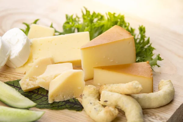 Choice of cheese platter on a wooden table