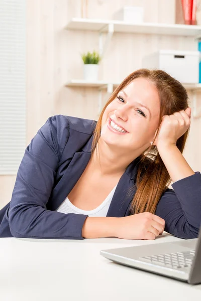 Happy successful young woman at work in the office with a beauti — Stock Photo, Image