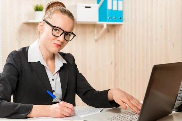 Business woman with black glasses working at a computer — Stock Photo, Image