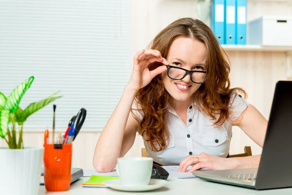Woman director  corrects glasses portrait at the office Royalty Free Stock Photos