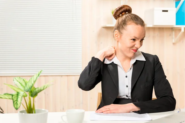 Tired accountant rubbing sore neck in the office — Stock Photo, Image