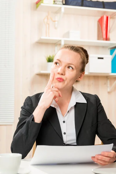 Serious financial analyst with documents in the office thinking — Stock Photo, Image