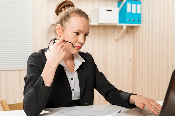 Tense female accountant working in the laptop in the office — Stock Photo, Image