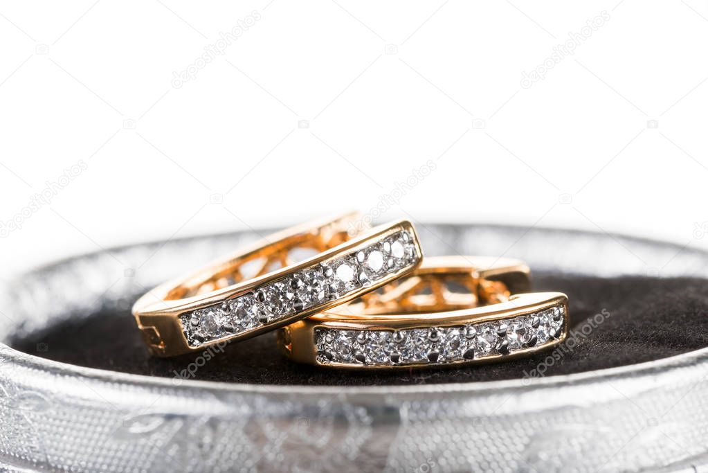 beautiful gold earrings with precious stones closeup