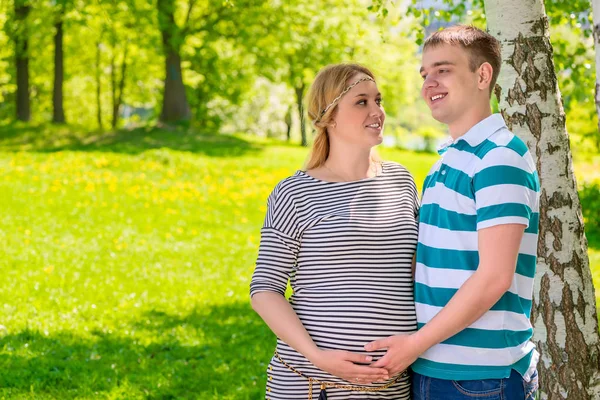 Future parents couple posing in the summer park — Stock Photo, Image