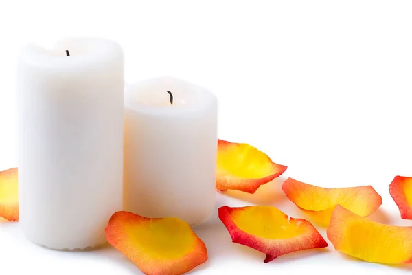 White candles and petals of tea-rose close up for a romantic moo Stock Photo