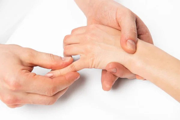 Hand massage, the masseur is working on every finger, close up p — Stock Photo, Image