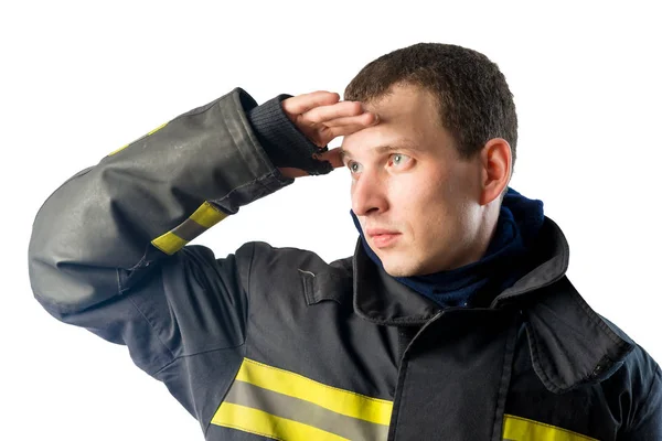 Fireman in protective suit looks off into the distance on a whit — Stock Photo, Image