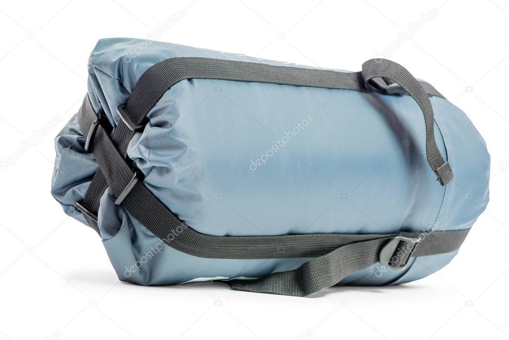 packed a sleeping bag in gray on a white background closeup