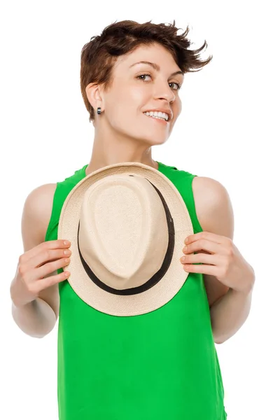 Happy smiling woman posing in a studio with a hat — Stock Photo, Image