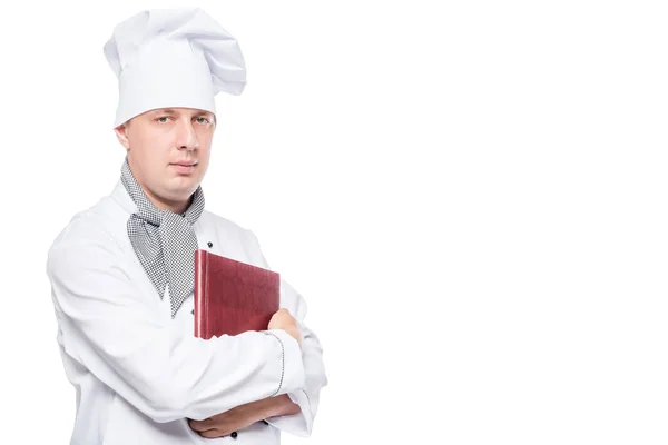 Schattig chef-kok met een menu in zijn handen poseren op een witte achtergrond — Stockfoto