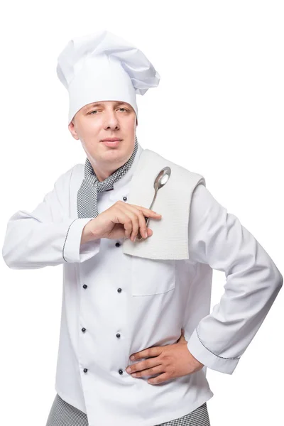 Portrait of a man in the uniform of the cook with a spoon and to — Stock Photo, Image