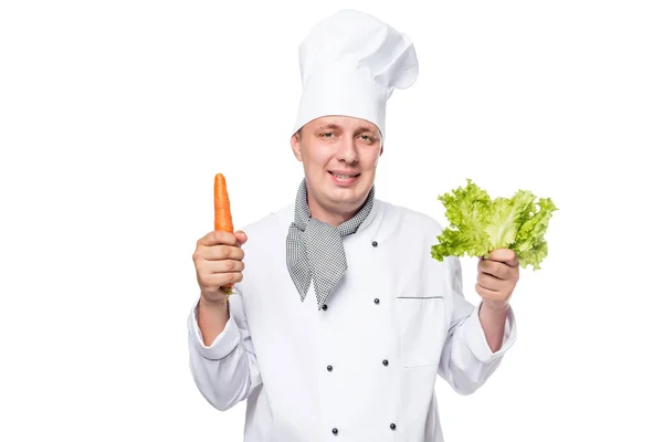 Portrait of a happy cook with fresh vegetables in the hands on a — Stock Photo, Image