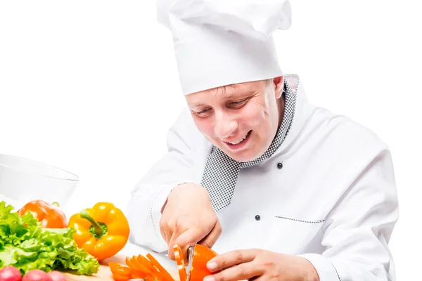 Happy smiling cook and cut peppers on a white table — Stock Photo, Image