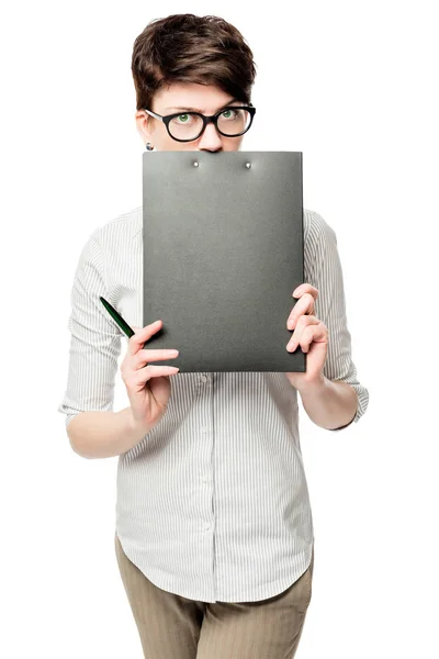 Business woman hiding behind a black folder on a white backgroun — Stock Photo, Image