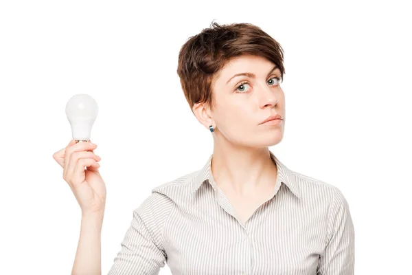 Business woman with a light bulb in hand on white background — Stock Photo, Image