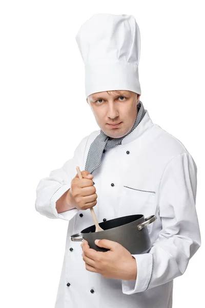 Serious experienced cook mixing with a wooden spoon food in a po — Stock Photo, Image