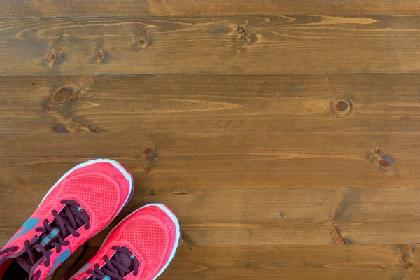 Une paire de chaussures pour femmes pour courir sur un sol en bois foncé et s — Photo
